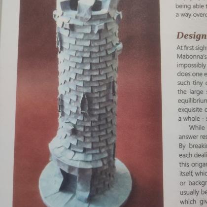 A medieval tower with detailed brickwork and a crown.